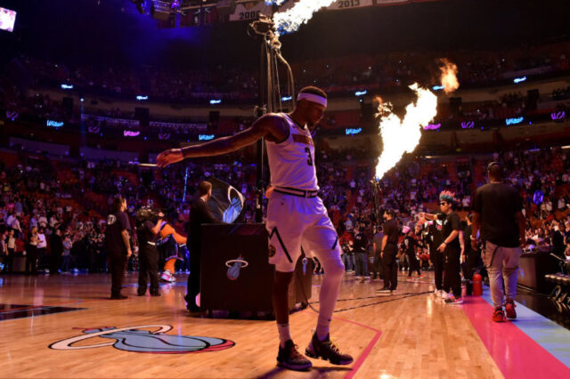 Denver Nuggets forward Torrey Craig (3) stretches as flames are seen while members of the Miami Heat are introduced at American Airlines Arena.