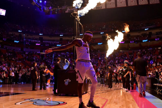 Denver Nuggets forward Torrey Craig (3) stretches as flames are seen while members of the Miami Heat are introduced at American Airlines Arena.