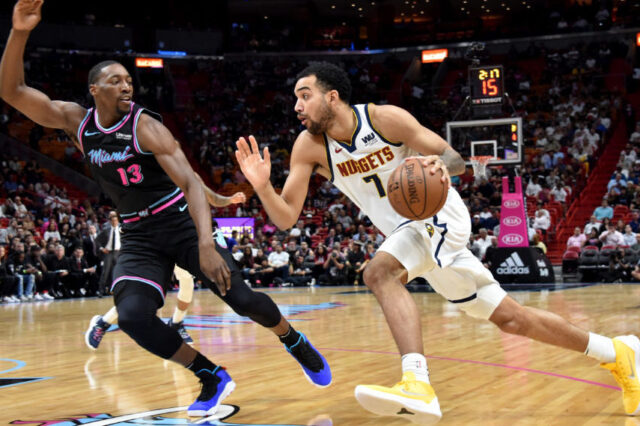 iami Heat center Bam Adebayo (13) pressures Denver Nuggets forward Trey Lyles (7) during the first half at American Airlines Arena.