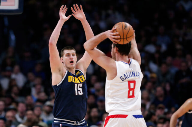 Denver Nuggets center Nikola Jokic (15) defends against Los Angeles Clippers forward Danilo Gallinari (8) in the second quarter at the Pepsi Center.