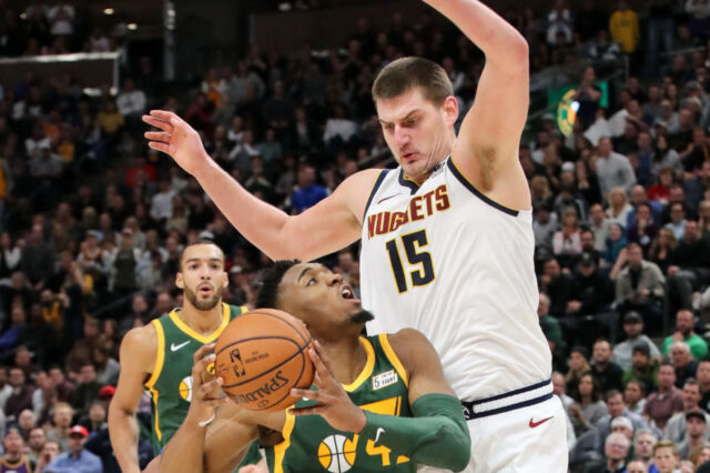 Utah Jazz guard Donovan Mitchell (45) drives against Denver Nuggets center Nikola Jokic (15) during the second half at Vivint Smart Home Arena. Utah won 114-108.