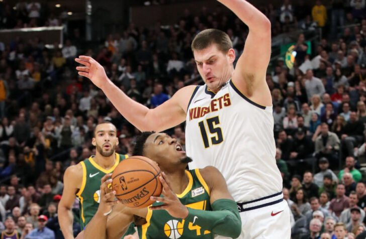 Utah Jazz guard Donovan Mitchell (45) drives against Denver Nuggets center Nikola Jokic (15) during the second half at Vivint Smart Home Arena. Utah won 114-108.