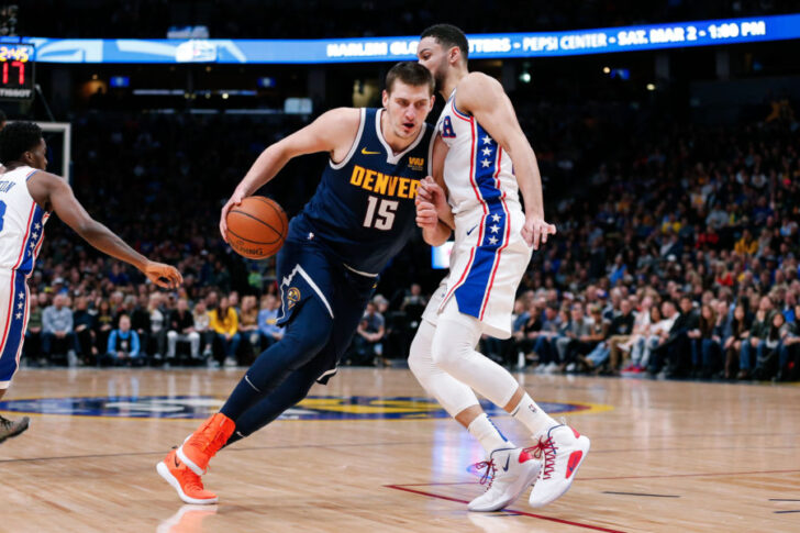 Denver Nuggets center Nikola Jokic (15) drives against Philadelphia 76ers guard Ben Simmons (25) in the first quarter at the Pepsi Center.