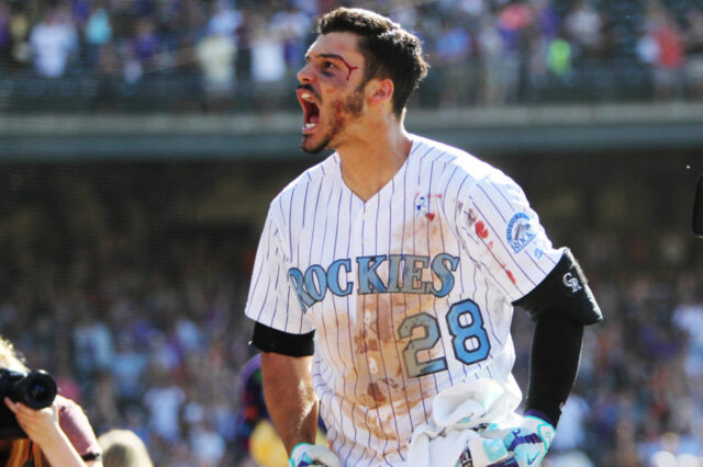 Colorado Rockies third baseman Nolan Arenado (28) celebrates after hitting a walk off three run home run to complete the cycle during the ninth inning against the San Francisco Giants at Coors Field.