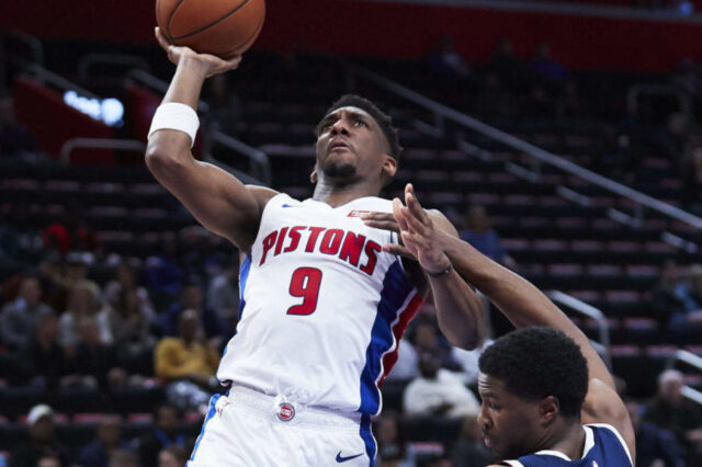 Detroit Pistons guard Langston Galloway (9) charges into Denver Nuggets guard Malik Beasley (25) in the second half at Little Caesars Arena.