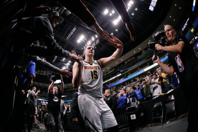 Denver Nuggets center Nikola Jokic (15) hi-fives fans after the game against the Oklahoma City Thunder at the Pepsi Center.