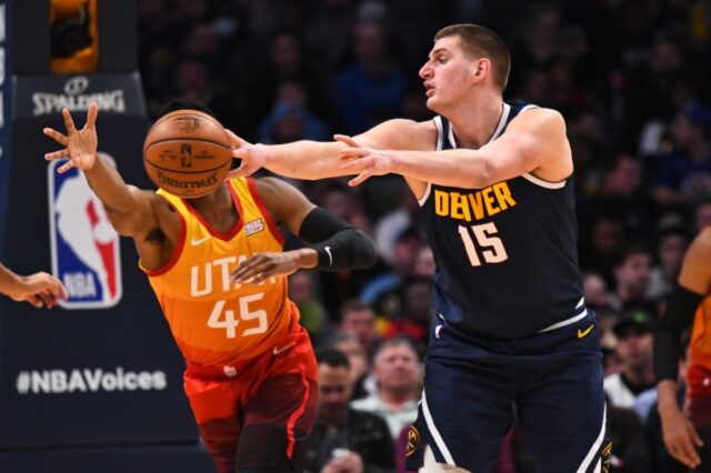 Denver Nuggets center Nikola Jokic (15) passes the ball past Utah Jazz guard Donovan Mitchell (45) in the second quarter at the Pepsi Center.