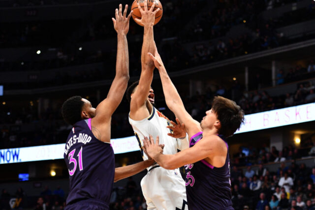 Minnesota Timberwolves forward Keita Bates-Diop (31) and forward Dario Saric (36) defend against Denver Nuggets guard Jamal Murray (27) in the first quarter at the Pepsi Center.