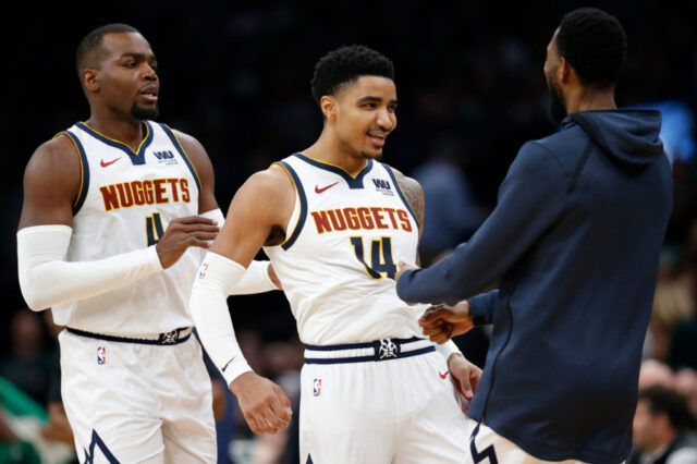 Denver Nuggets center Paul Millsap (4) and guard Gary Harris (14) celebrate during the second half against the Boston Celtics at TD Garden.