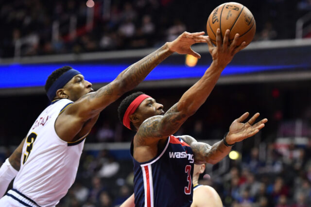 Washington, DC, USA; Washington Wizards guard Bradley Beal (3) shoots as Denver Nuggets forward Torrey Craig (3) defends during the second half at Capital One Arena.