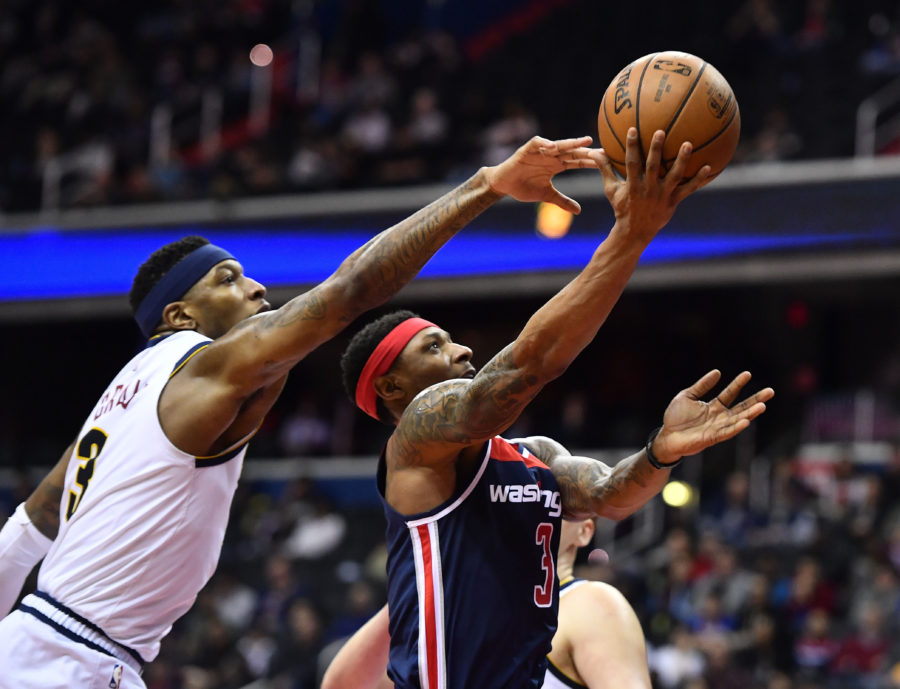 Washington, DC, USA; Washington Wizards guard Bradley Beal (3) shoots as Denver Nuggets forward Torrey Craig (3) defends during the second half at Capital One Arena.