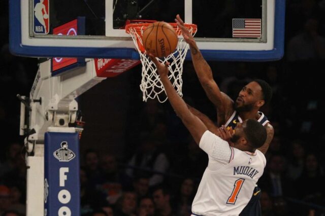 Denver Nuggets shooting guard Will Barton (5) blocks a shot by New York Knicks point guard Emmanuel Mudiay (1) during the first quarter at Madison Square Garden.