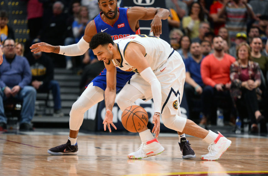 Detroit Pistons guard Wayne Ellington (top) pressures Denver Nuggets guard Jamal Murray (27) in the second half at the Pepsi Center.