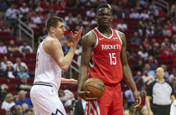 Denver Nuggets center Nikola Jokic (15) and Houston Rockets center Clint Capela (15) react after a play during the first quarter at Toyota Center.