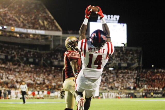 Mississippi Rebels wide receiver D.K. Metcalf (14) catches a touchdown pass as Florida State Seminoles defensive back Tarvarus McFadden (4) defends in the second quarter at Camping World Stadium.