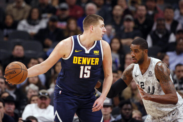 Denver Nuggets center Nikola Jokic (15) posts up against San Antonio Spurs power forward LaMarcus Aldridge (12) during the first half at AT&T Center.