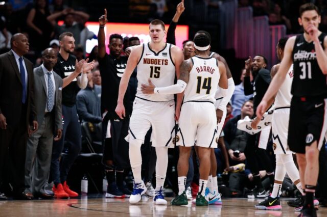 Denver Nuggets guard Gary Harris (14) talks with center Nikola Jokic (15) after he receives a double technical foul and is ejected in the fourth quarter against the Washington Wizards at the Pepsi Center.