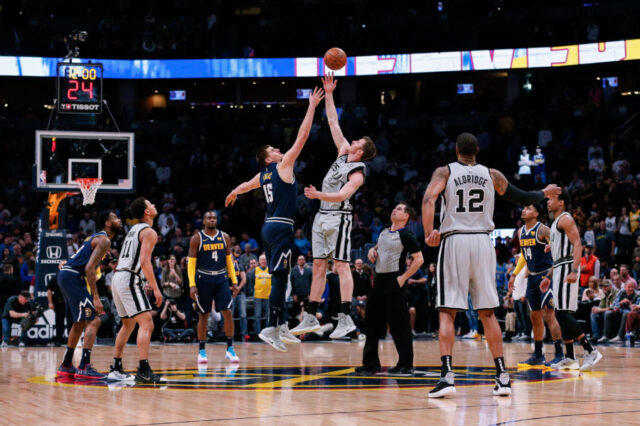 San Antonio Spurs center Jakob Poeltl (25) wins the tip off against Denver Nuggets center Nikola Jokic (15) in the first quarter at the Pepsi Center