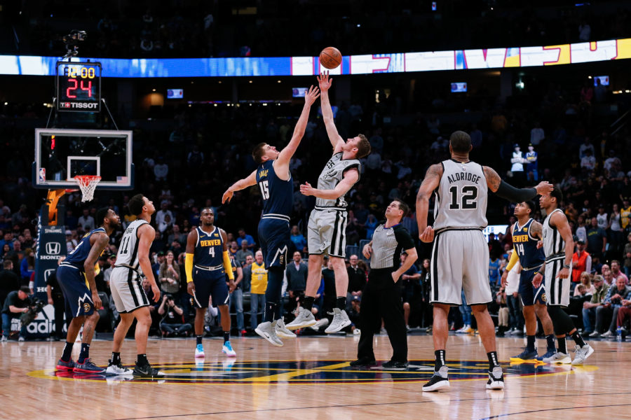 San Antonio Spurs center Jakob Poeltl (25) wins the tip off against Denver Nuggets center Nikola Jokic (15) in the first quarter at the Pepsi Center