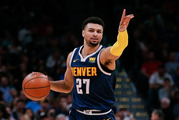 Denver Nuggets guard Jamal Murray (27) motions as he dribbles the ball up court in the second quarter against the San Antonio Spurs at the Pepsi Center.