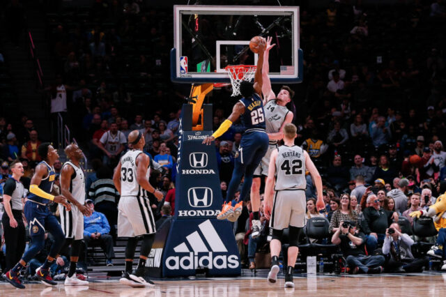 Denver Nuggets guard Malik Beasley (25) dunks the ball against San Antonio Spurs forward Drew Eubanks (14) as forward Dante Cunningham (33) and forward Davis Bertans (42) watch in the fourth quarter at the Pepsi Center.