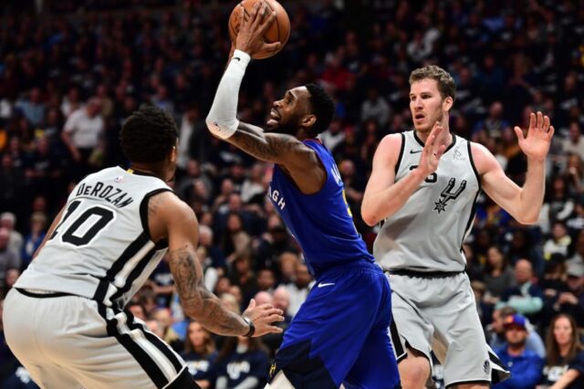 Denver Nuggets guard Will Barton (5) shoots over San Antonio Spurs guard DeMar DeRozan (10) in the second quarter of the first round of the 2019 NBA Playoffs at Pepsi Center.