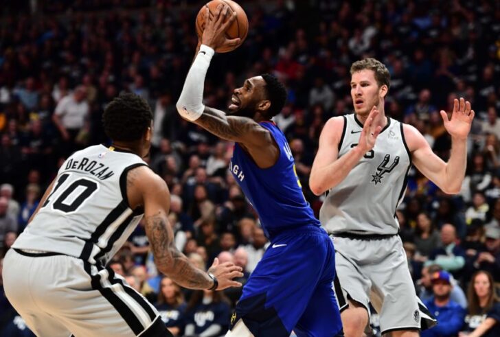 Denver Nuggets guard Will Barton (5) shoots over San Antonio Spurs guard DeMar DeRozan (10) in the second quarter of the first round of the 2019 NBA Playoffs at Pepsi Center.