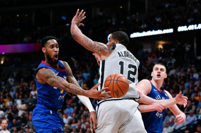 Denver Nuggets guard Will Barton (5) passes the ball to center Nikola Jokic (15) around San Antonio Spurs center LaMarcus Aldridge (12) in the second quarter at the Pepsi Center.