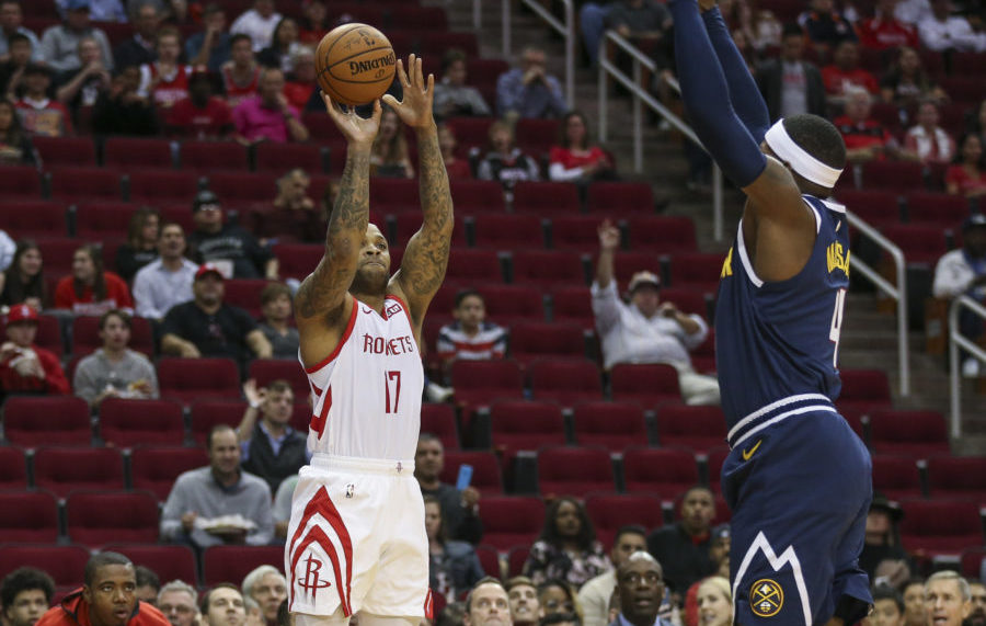 Houston Rockets forward PJ Tucker (17) shoots the ball against Denver Nuggets forward Paul Millsap (4) during the first quarter at Toyota Center.