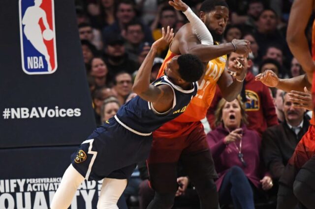 Denver Nuggets guard Monte Morris (11) is elbowed by Utah Jazz forward Royce O'Neale (23) in the second quarter at the Pepsi Center.