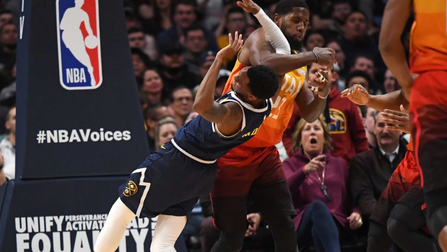 Denver Nuggets guard Monte Morris (11) is elbowed by Utah Jazz forward Royce O'Neale (23) in the second quarter at the Pepsi Center.