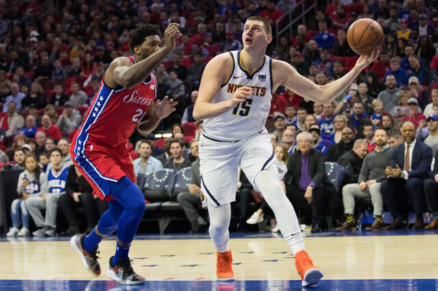 Denver Nuggets center Nikola Jokic (15) shoots the ball past Philadelphia 76ers center Joel Embiid (21) during the first quarter at Wells Fargo Center.