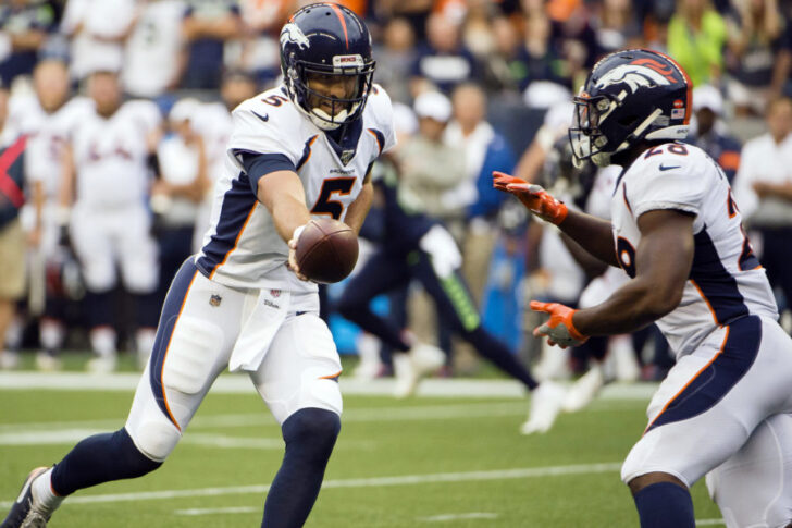 Denver Broncos quarterback Joe Flacco (5) hands off to running back Royce Freeman (28) during the first half agains the Seattle Seahawks at CenturyLink Field.