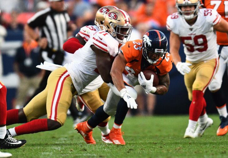 San Francisco 49ers defensive tackle Jullian Taylor (71) tackles Denver Broncos running back Devontae Booker (23) in the second quarter at Broncos Stadium at Mile High.