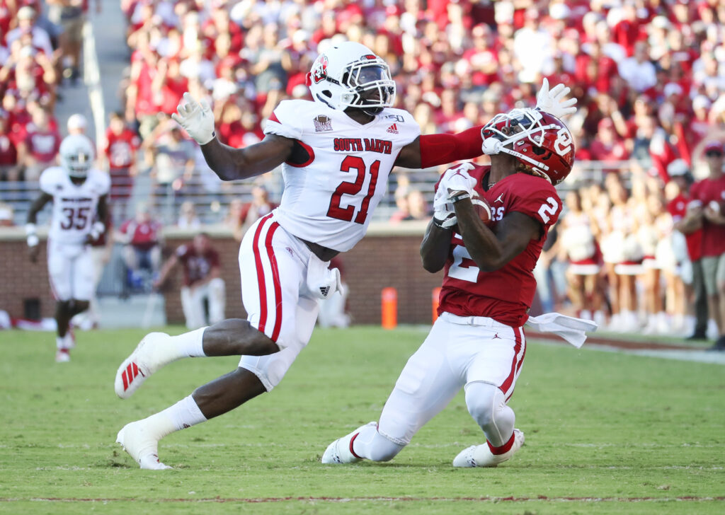 Oklahoma Sooners wide receiver CeeDee Lamb (2) makes a catch over South Dakota Coyotes defensive back Phillip Powell (21) during the first quarter at Gaylord Family - Oklahoma Memorial Stadium