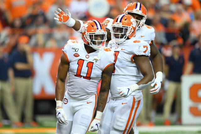 Clemson Tigers linebacker Isaiah Simmons (11) reacts to a defensive play with teammates defensive end Justin Mascoll (7) and defensive tackle Xavier Kelly (back) against the Syracuse Orange during the third quarter at the Carrier Dome.