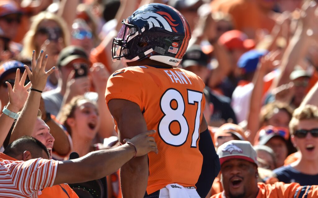 Noah Fant jumps into the crowd after his first touchdown. Credit: Michael Madrid, USA TODAY Sports.