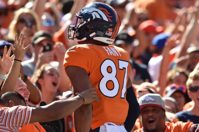 Noah Fant jumps into the crowd after his first touchdown. Credit: Michael Madrid, USA TODAY Sports.