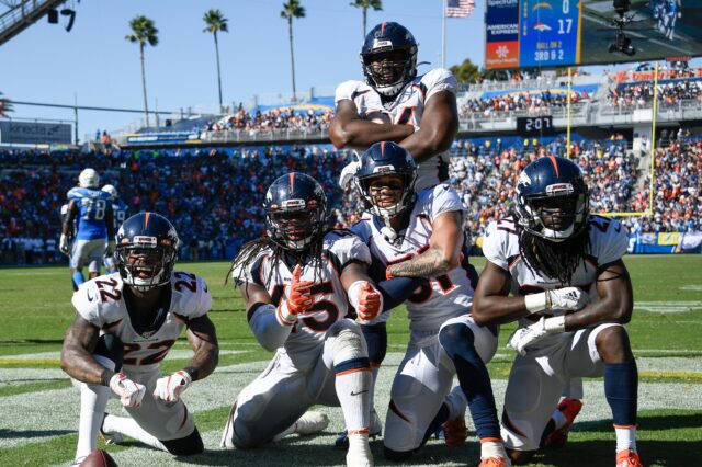 Kareem Jackson, Todd Davis and Alexander Johnson celebrate Johnson's huge interception with teammates. Credit: Robert Hanashiro, USA TODAY Sports.