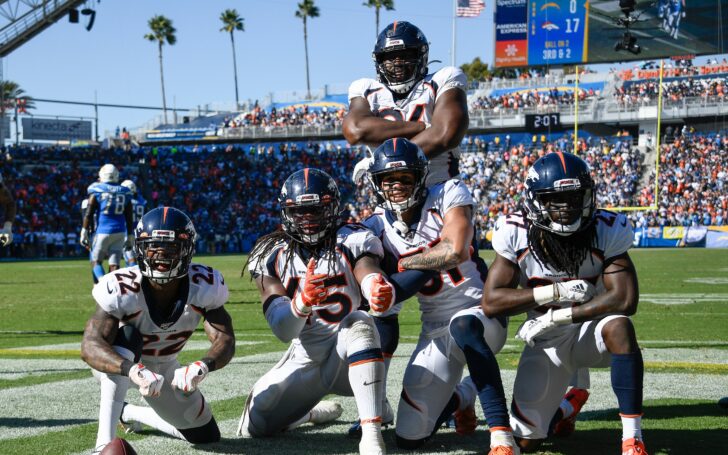 Kareem Jackson, Todd Davis and Alexander Johnson celebrate Johnson's huge interception with teammates. Credit: Robert Hanashiro, USA TODAY Sports.