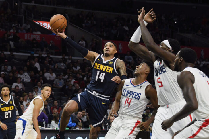 Denver Nuggets guard Gary Harris (14) drives against LA Clippers guard Terance Mann (14) and forward Montrezl Harrell (5) and forward JaMychal Green (right) during the second half at Staples Center.