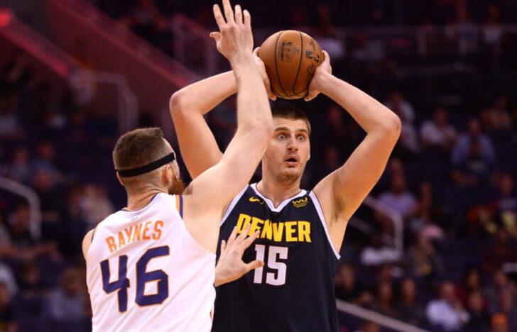 Denver Nuggets center Nikola Jokic (15) controls the ball against Phoenix Suns center Aron Baynes (46) during the second half at Talking Stick Resort Arena.