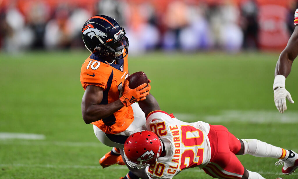 Kansas City Chiefs cornerback Morris Claiborne (20) tackles Denver Broncos wide receiver Emmanuel Sanders (10) in the second quarter at Empower Field at Mile High.