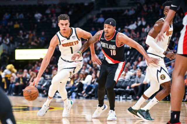 Denver Nuggets forward Michael Porter Jr. (1) dribbles past Portland Trail Blazers guard Troy Caupain (10) during the second half at Pepsi Center.