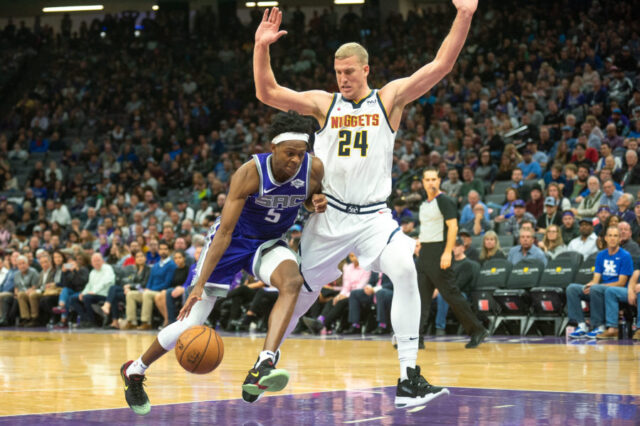 Sacramento Kings guard De'Aaron Fox (5) drives to the basket against Denver Nuggets forward Mason Plumlee (24) during the fourth quarter at Golden 1 Center.