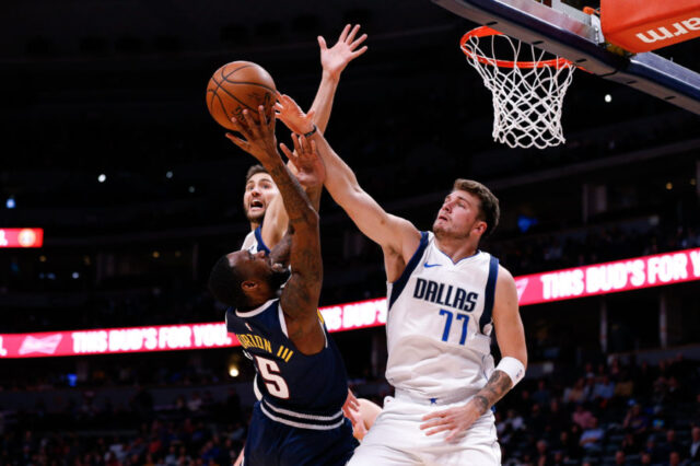 Denver Nuggets guard Will Barton III (5) shoots against Dallas Mavericks forward Maxi Kleber (42) and forward Luka Doncic (77) in the second quarter at the Pepsi Center.