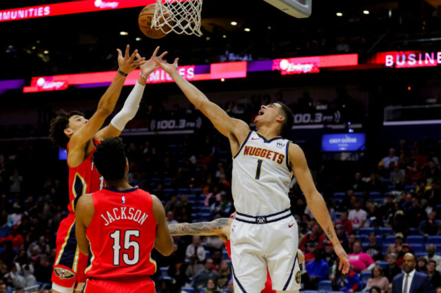 New Orleans Pelicans center Jaxson Hayes (10) rebounds over Denver Nuggets forward Michael Porter Jr. (1) during the first quarter at the Smoothie King Center.