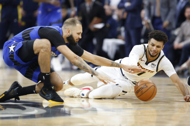 Orlando Magic guard Evan Fournier (10) goes for the ball against Denver Nuggets guard Jamal Murray (27) for a loose ball during the second half at Amway Center.