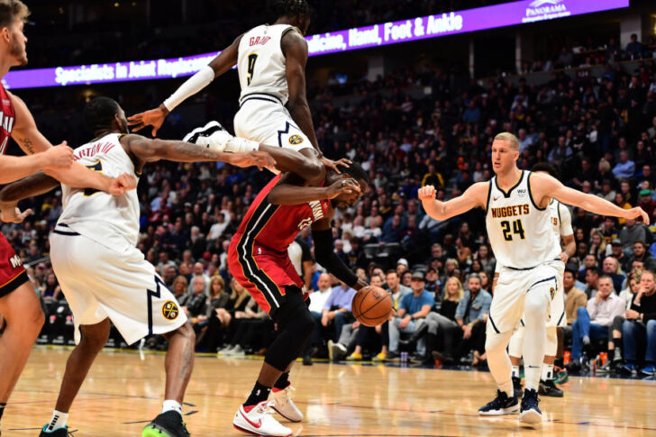 Denver Nuggets forward Jerami Grant (9) lands on the back of Miami Heat forward Bam Adebayo (13) in the third quarter at the Pepsi Center.