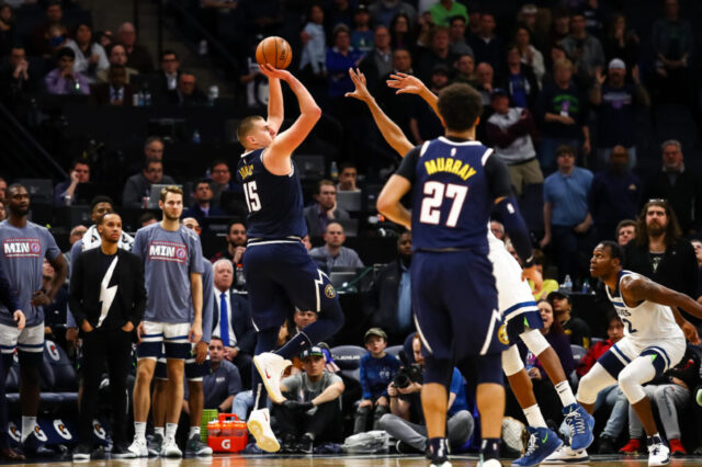 Denver Nuggets center Nikola Jokic (15) shoots the ball against the Minnesota Timberwolves during overtime at Target Center.